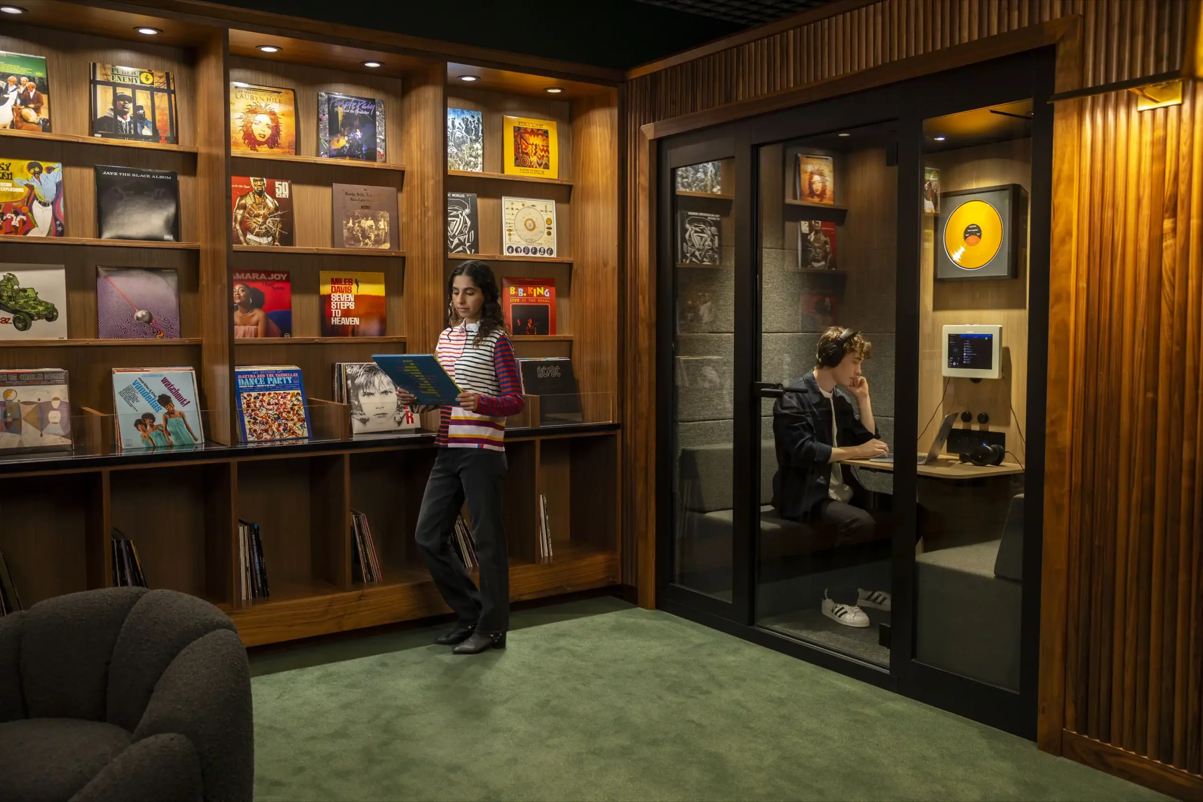 model inside a listening booth at a listening lounge